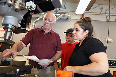 Students and Professor with Machining Tool