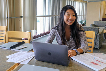 Student With Laptop in Library