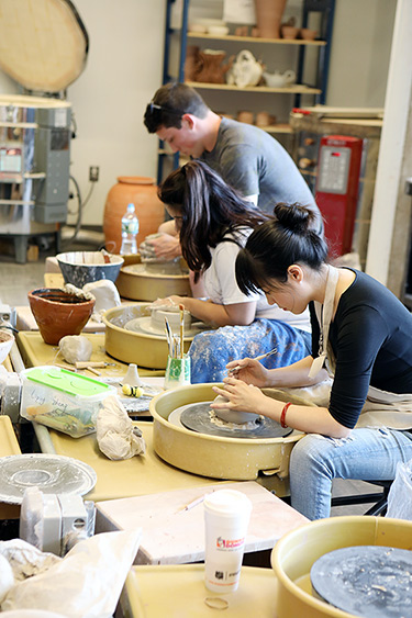 Students Using Pottery Wheels